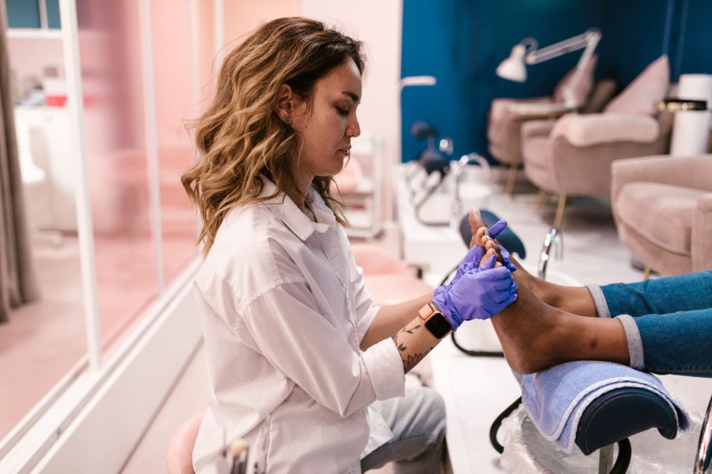 The Art of Drawing Readers In: Your attractive post title goes here Woman giving pedicure treatment in a stylish modern salon. Beauty care focused.